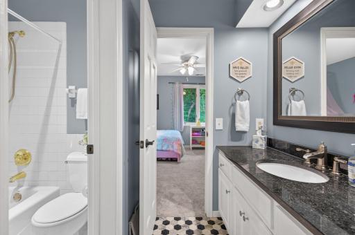 Jack n Jill bath with well-sized vanity, adequate storage, and separate stool and bathtub room