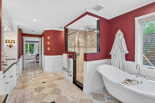 Detailed tiled walk-in shower surrounded by glass shower door enclosure
