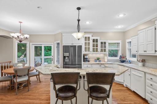 Raised Granite top center island offers additional seating to the adjacent dinette area