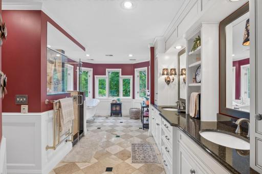 As you enter the bath, the feel of a spa is real. Tiled floors, Dual sink vanity separated by built-in with drawer stack below. Appreciate the windows also viewing treed lot.