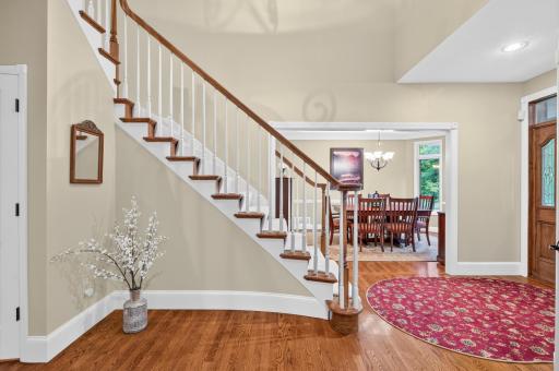 Detailed staircase with wood treads, enameled spindles- and viewing of formal dining room