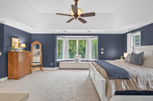 View of the primary bedroom overlooking the secluded backyard