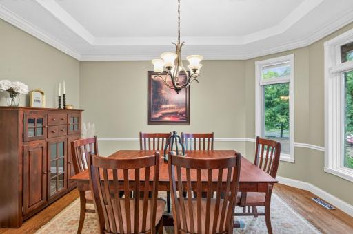 Another view of formal dining room with detailed ceiling