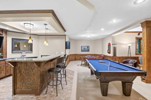Tiled Bar area with hard surface tops, detailed ceiling , and pendent lighting