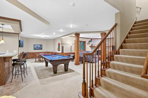 Welcome to the lower level walk-out that is incredible space that should meet all ones needs from entertaining, to exercising, to "chilling out", playing games, pool or enjoying a beverage at the bar.