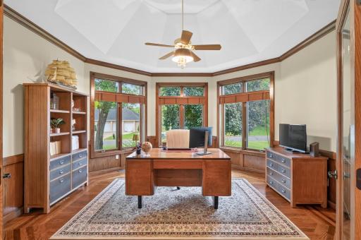 What an office to get to work in! If you need an in-home office, you ll appreciate all this has to offer.
Detail Ceiling with coving and ceiling fan, wood floor, Bowed out foundation for character with 3 windows- transoms above.