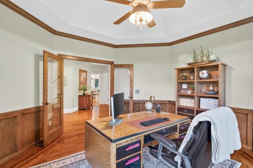 Office space offers french glass doors allowing for privacy if needed or open to the other areas of the home. Wainscoating on the walls finishes off the space well.