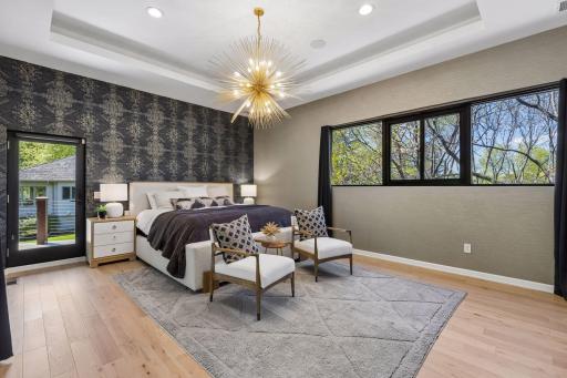 Upstairs, the luxurious primary suite offers a spa-like bathroom and private balcony retreat.