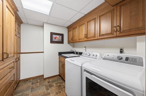 Updated lower level laundry room with built-ins and plenty of room for storage. Even has crown molding!!