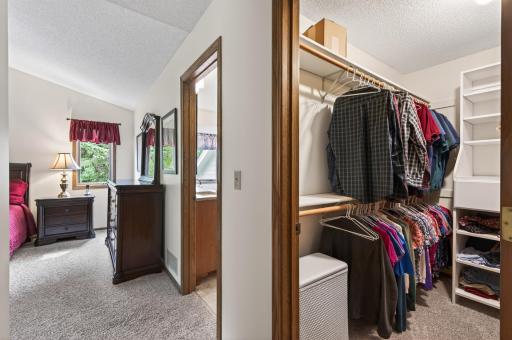 Large walk-in closet with built-ins in owners' suite