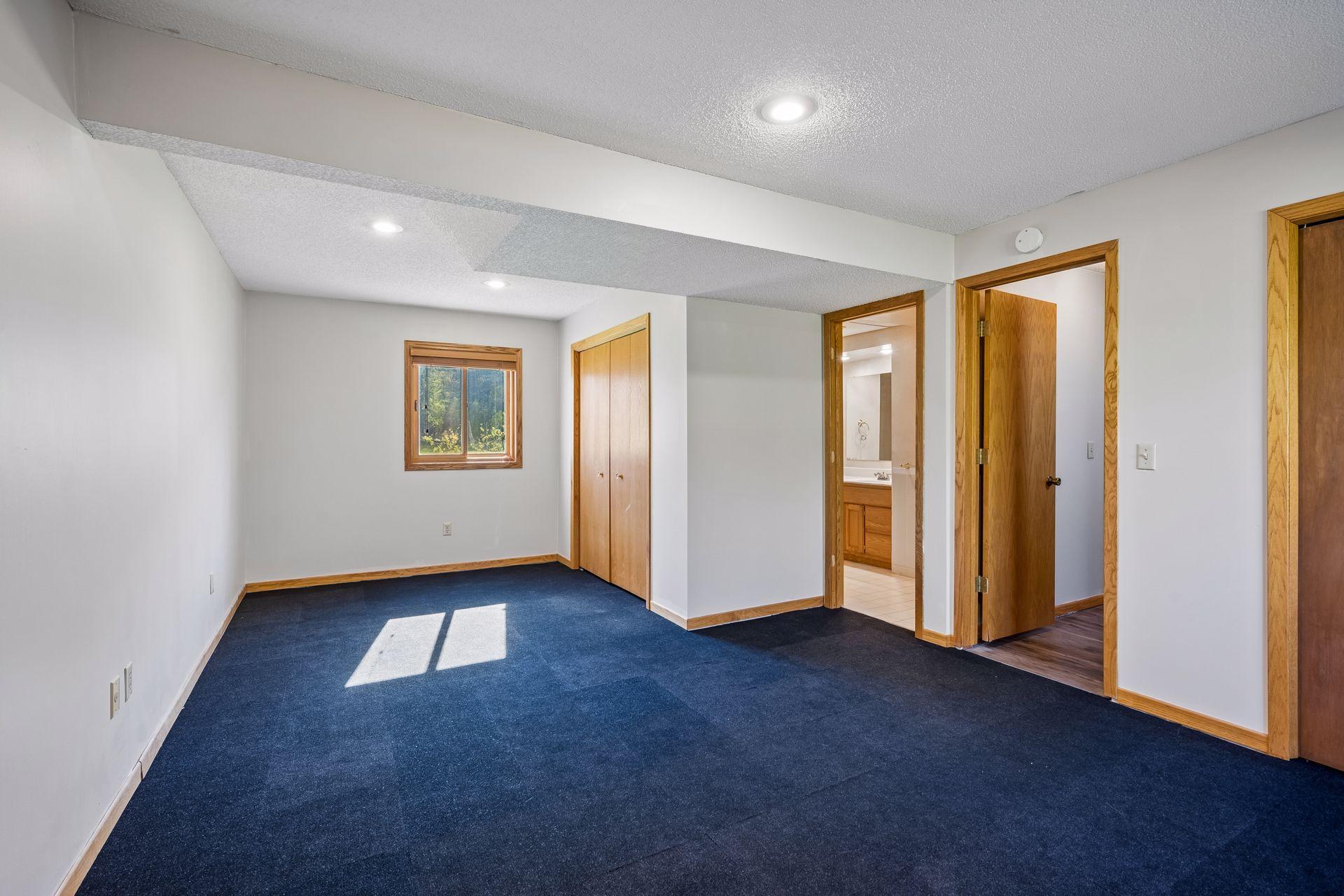 The lower level primary bedroom is large enough to accomodate a king size bed.