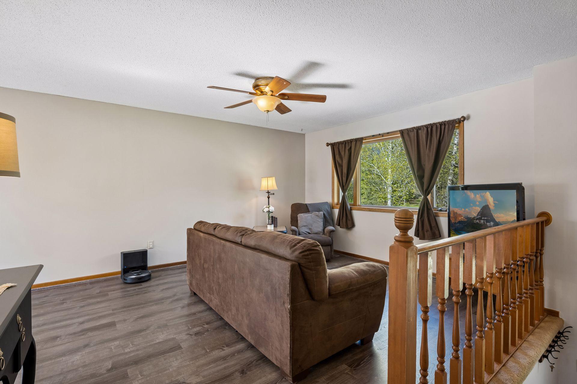 Large living room with laminate flooring.