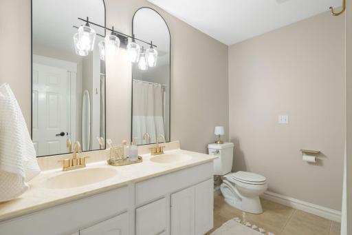 All three bedrooms are conveniently located near the shared full bathroom, complete with a double vanity and tub and shower combination.
