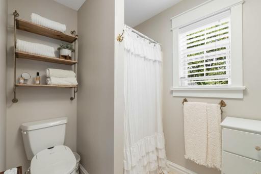 The private Â¾ bathroom features a unique vanity and walk-in shower.