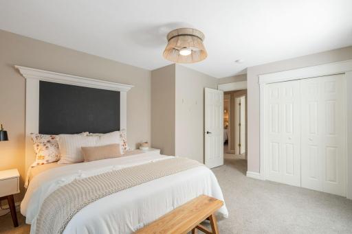 Bedroom three features a unique built-in wall headboard, distinctive ceiling fan with light fixture, and ample closet space.