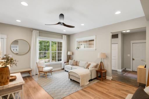 Flanking the welcoming entry are two spacious living rooms, each featuring large picture windows and recessed lighting.