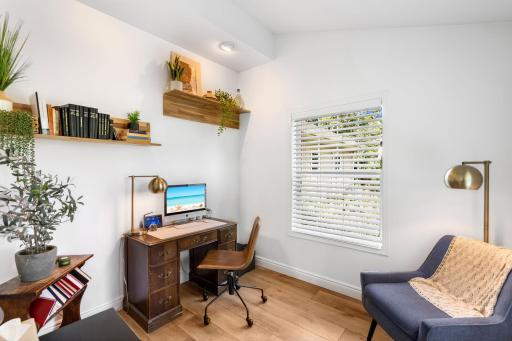 The main level also offers a versatile office or den with luxury plank floors and rear-facing windows.