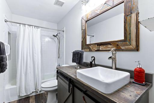 Updated, upper level full bath with tile shower.