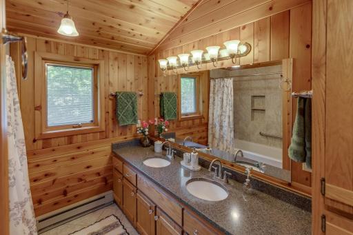 Upper level full bath with double sinks and large soaking tub and lots of closet/storage space.