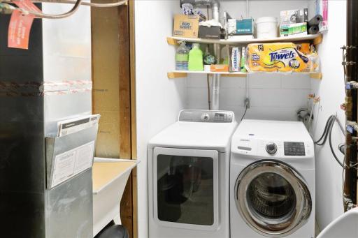 Lower level mechanical room with washer and dryer.