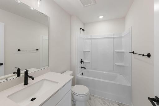 Full Bathroom features white cabinets and gold hardware - for illustrative purposes only