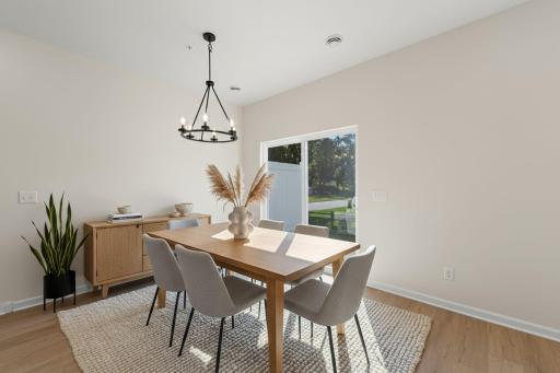 Dining room features gold light fixture - for illustrative purposes only