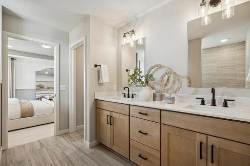 Generous vanity with ample counter space and under-sink storage provides both practicality and style, ideal for everyday routines.