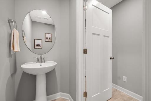 Main floor powder room bath and three panel doors throughout.