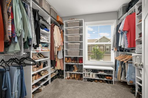 Customized closet organizer in primary closet. Space all it all