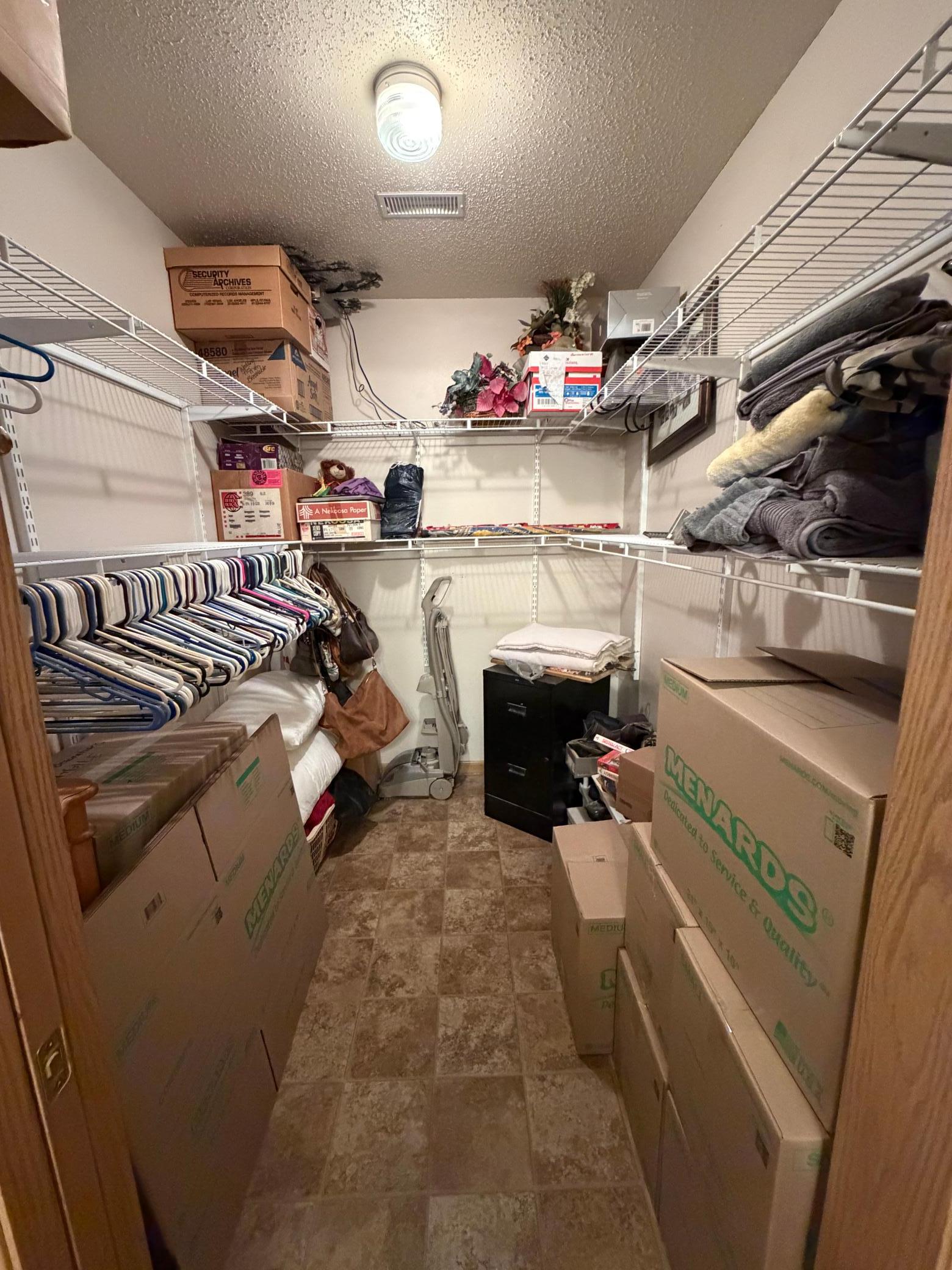 Walk in closet in primary bedroom
