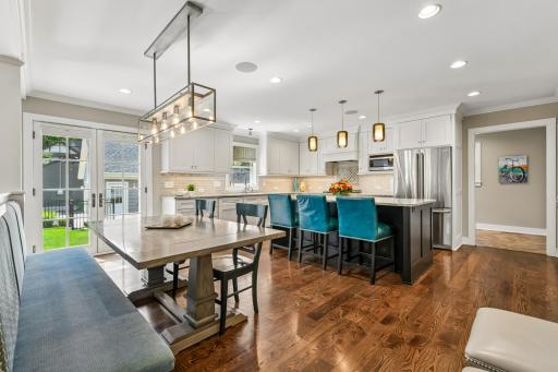 Built in bench for dining table gives flexibility for space and ease. Custom light fixtures throughout.
