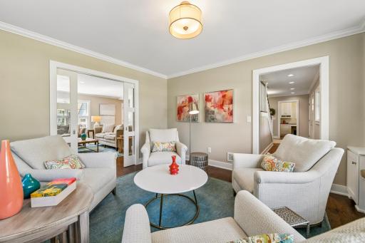 View from corner of front living room into the main level family room and hallway to the front door showing front office in the background. What a great space to enjoy year-round.