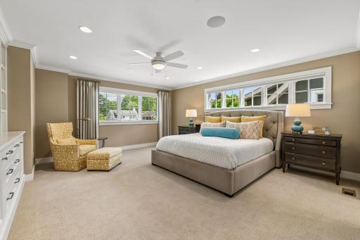 Stunning primary suite with tons of light, custom draperies and built ins.