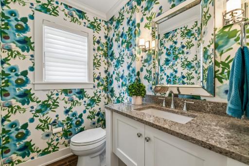 Main level half bath directly located off kitchen and front entry. Beautiful granite vanity and hardwood floors.