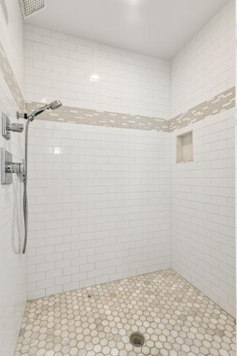 Floor to ceiling tile surround primary shower
