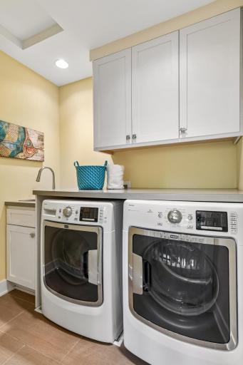 Buyers will appreciate and enjoy the tiled upper-level laundry room with utility sink, folding countertop and storage cabinets.