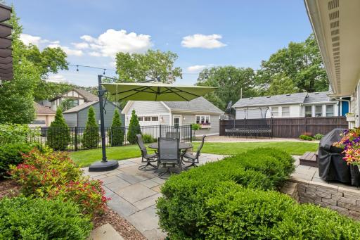 View of lush backyard from corner with green space to play and enjoy along with partial fencing. Don't forget the oversized 2 car garage.