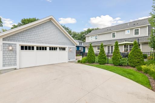 The view as you enter your backyard and drive into the oversized 2.5 car garage. Lush landscape greets you with fencing and gate