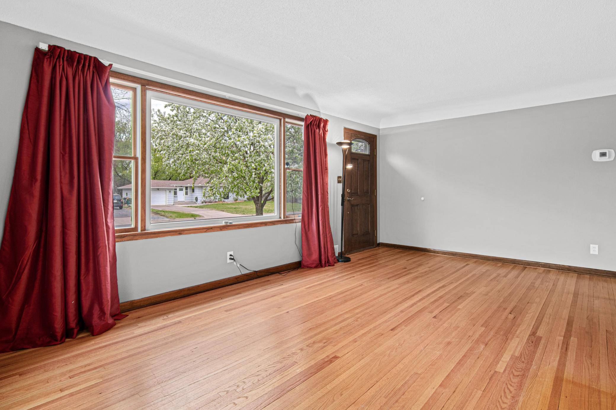 Bright and open living room with original hardwood floors .jpg