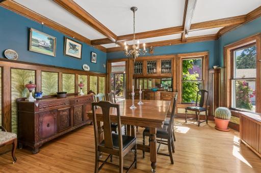 Spacious dining room with an original built-in buffet, classic wainscoting, and beamed ceilings.