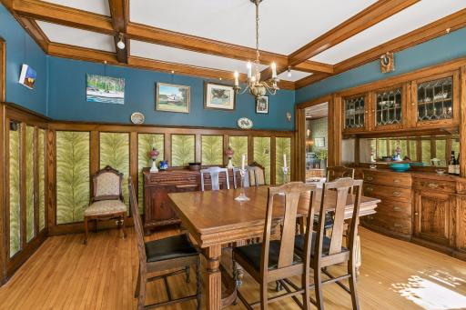 Spacious dining room with an original built-in buffet, classic wainscoting, and beamed ceilings.