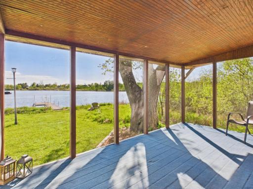 Enjoy the screened in porch with a relaxing view.