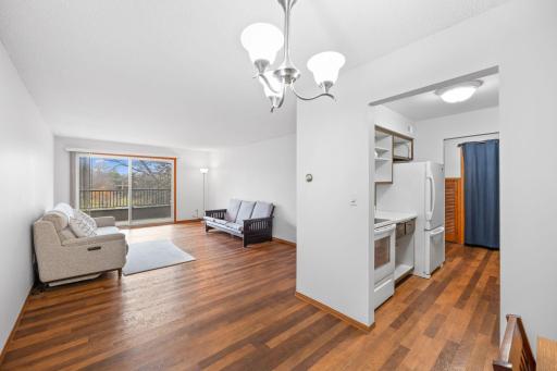open living room with lots of light transitions to dining area and kitchen