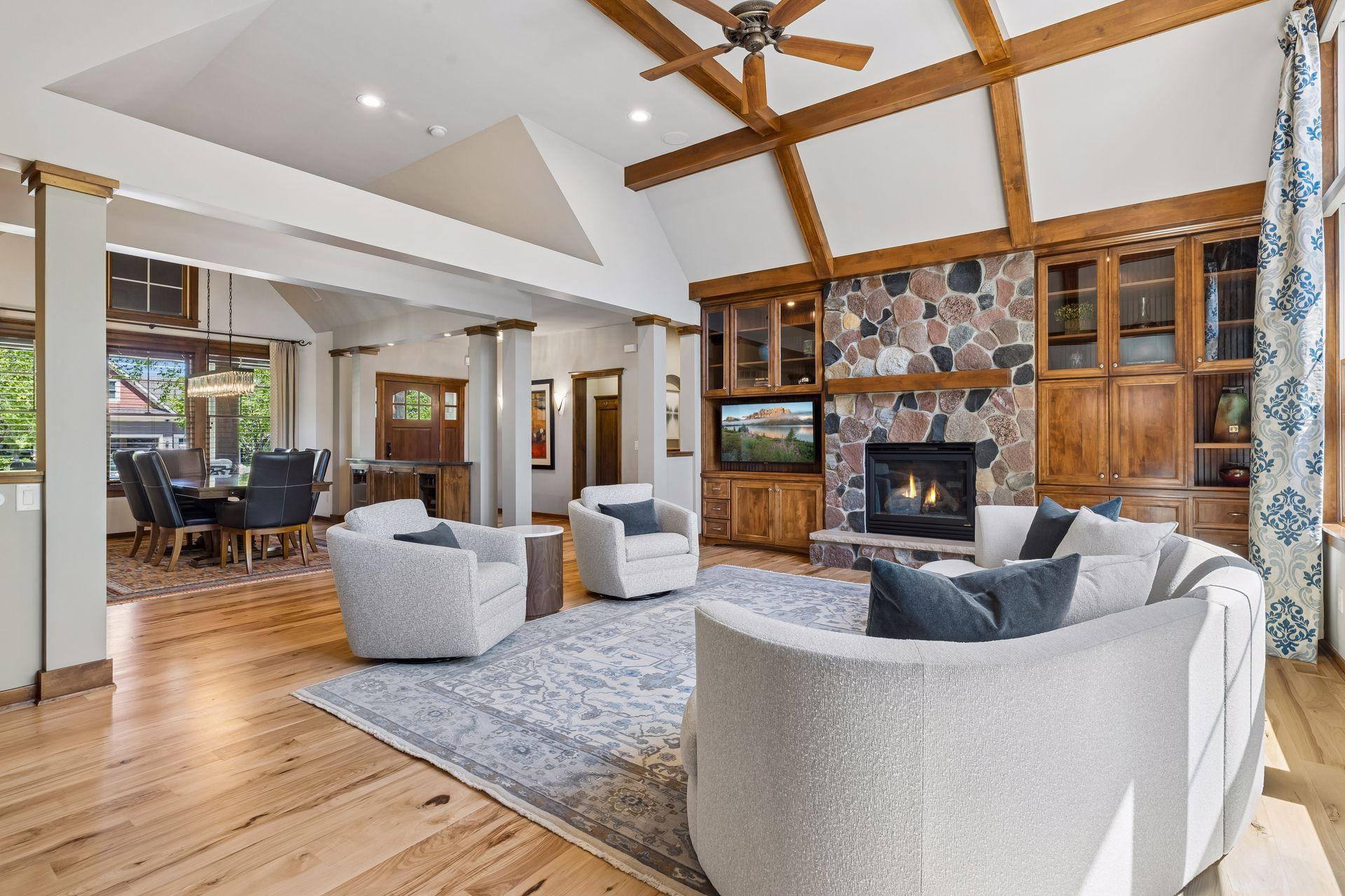 Open layout of the formal living room and dining room. The large wall of windows fills the rooms with natural light.