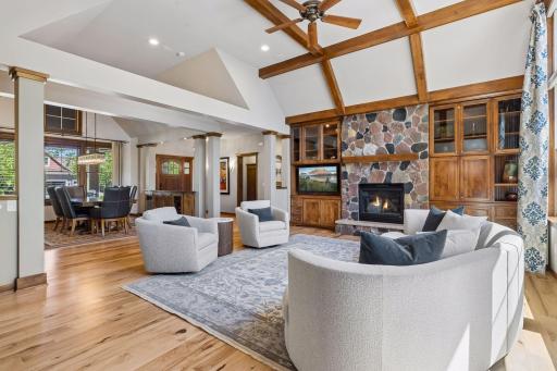 Open layout of the formal living room and dining room. The large wall of windows fills the rooms with natural light.