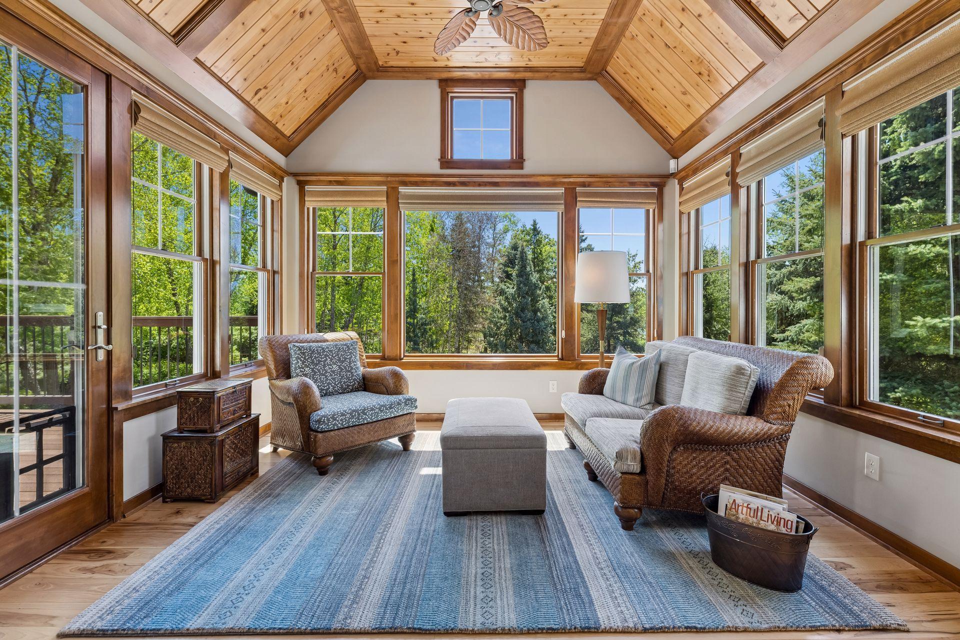 Cozy up in this peaceful sunroom with its vaulted cedar tongue & groove knotty pine ceiling with a ceiling fan, large picture window overlooking the gorgeous backyard & access to the new TimberTech maintenance-free backyard deck (15' x 11'9") 2025.