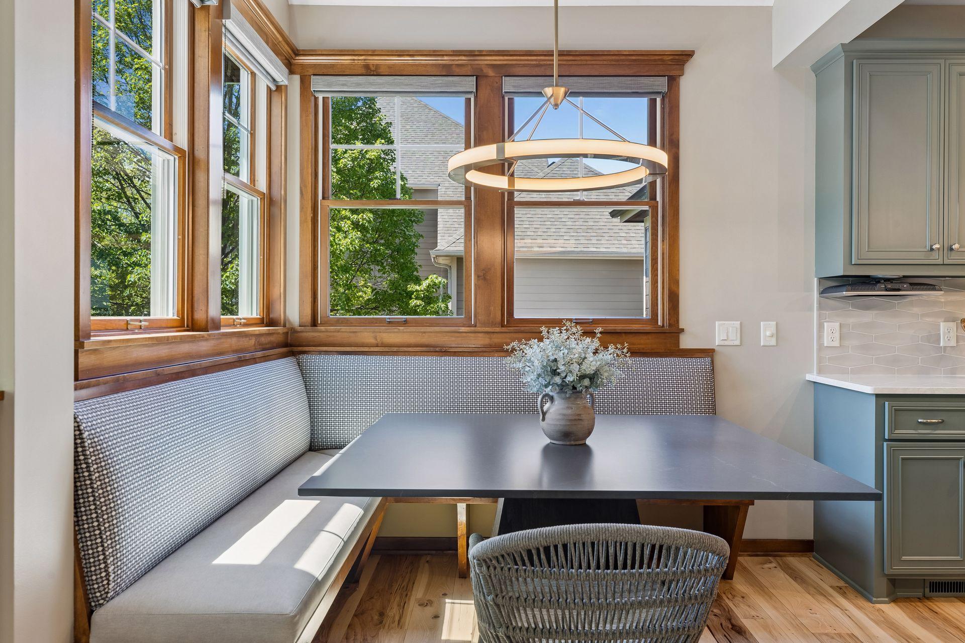Plenty of informal seating at the island & the corner banquette surrounded by windows. The ceiling in the dining area is vaulted giving it a bright, open feel.