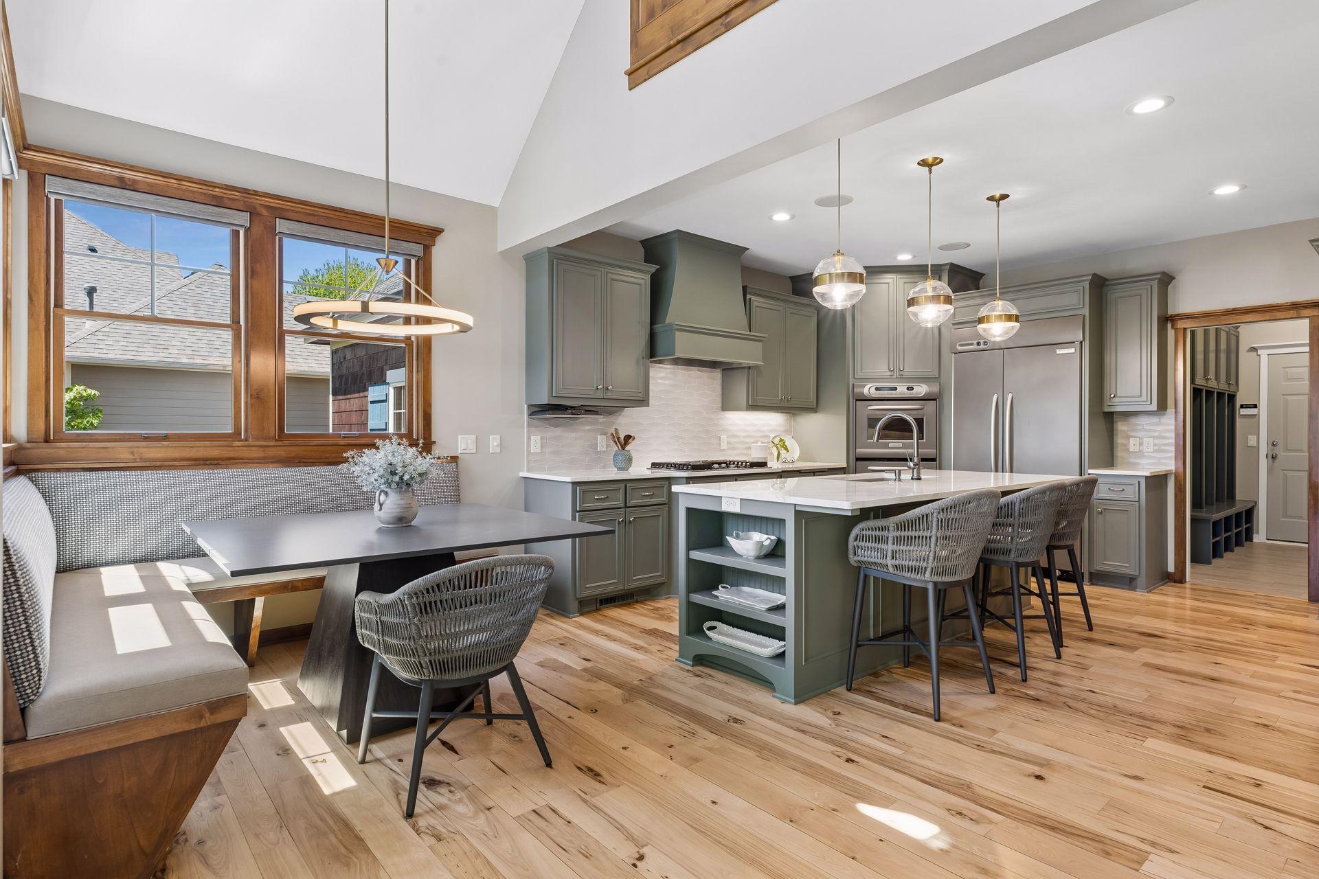 The beautiful hickory floors continue in the kitchen. The room is accented with ceramic tile backsplash, pendant & recessed lights & is wired for surround sound. The mudroom with garage service access is conveniently located just off the kitchen.