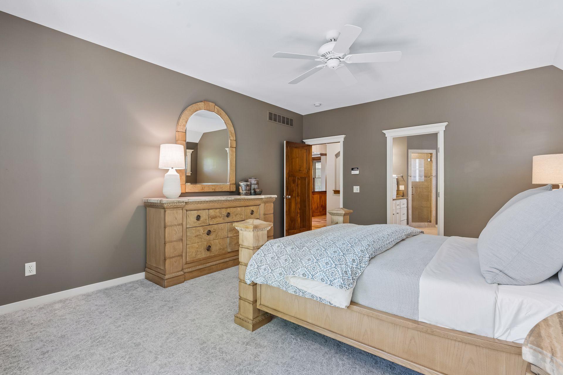 Another view of the primary bedroom showing the layout and access to the private bathroom and walk-in closet.