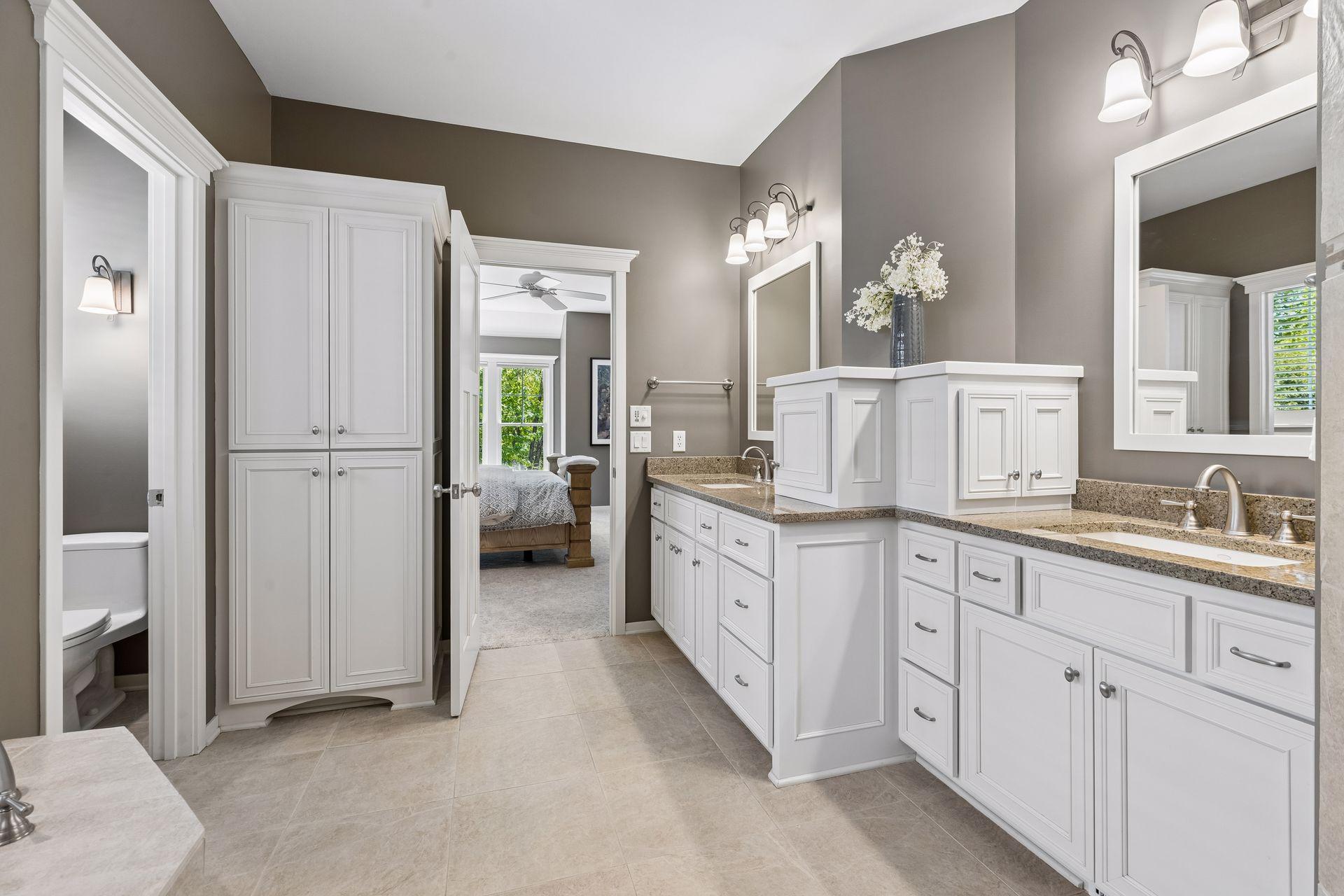 This view highlights all the storage included in the comfort-height vanity and the double linen closet.